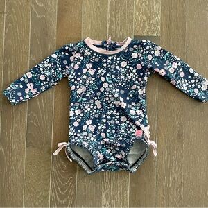 RuffleButts Floral Long Sleeve Swimsuit (12–18M) 🌸